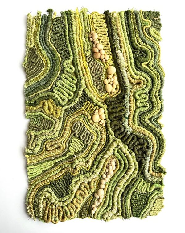Textural textile art piece in varying hues of green